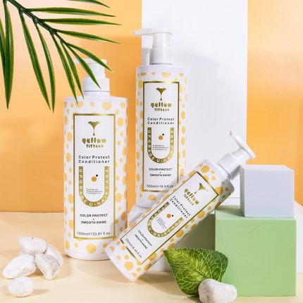 Three white hair‑care bottles with yellow polka dots labeled Color Protect Conditioner on an orange/white backdrop with a green leaf nearby.