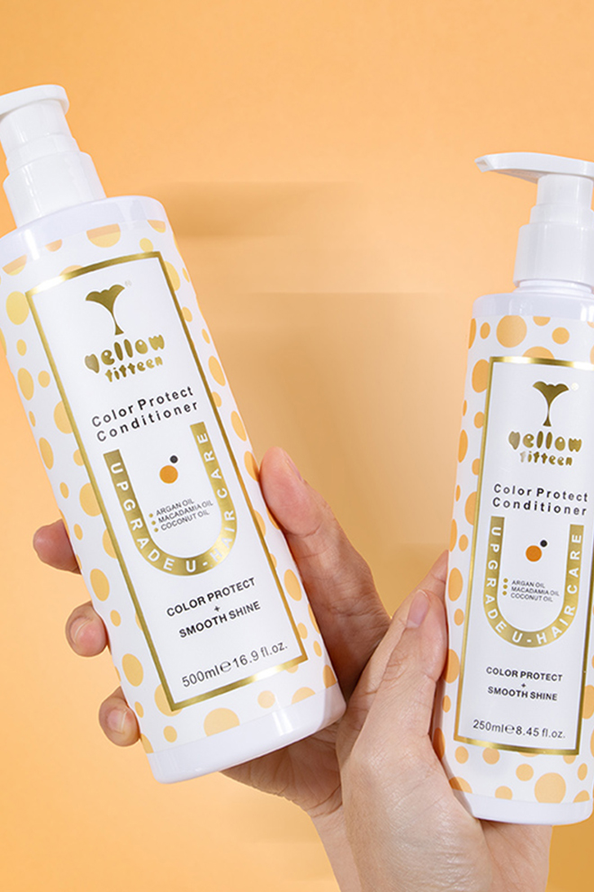 Two white bottles with yellow polka dots are held by hands against a peach background; the labels read Color Protect Conditioner and Smooth Shine.