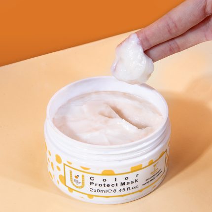 Open white jar labeled Color Protect Mask with a finger lifting a dollop of creamy mask from the container货.