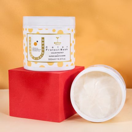 White jar of Color Protect Mask with a yellow polka-dot label atop a red box, against an orange background, with the open tub showing creamy product nearby.