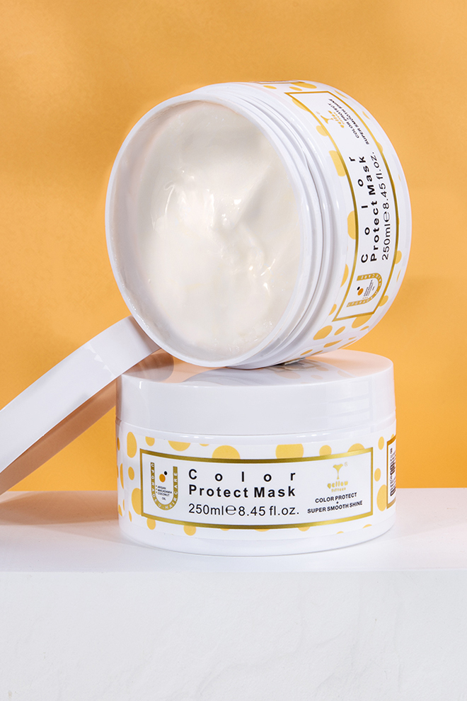 Two white cosmetic jars with yellow polka-dot packaging, labeled "Color Protect Mask" on an orange background (250 ml).
